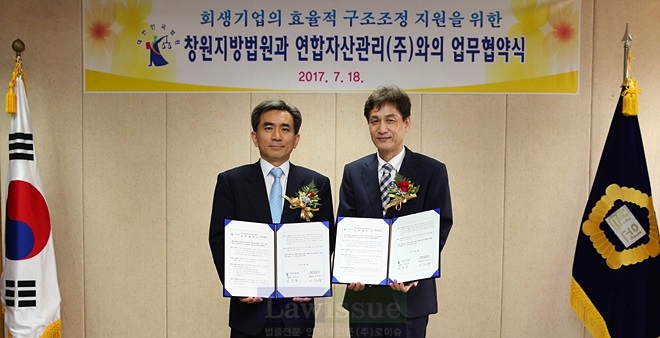 박효관 법원장(사진왼쪽)과 이성규 대표이사가 업무협약서를 내보이며 기념촬영을 하고 있다.