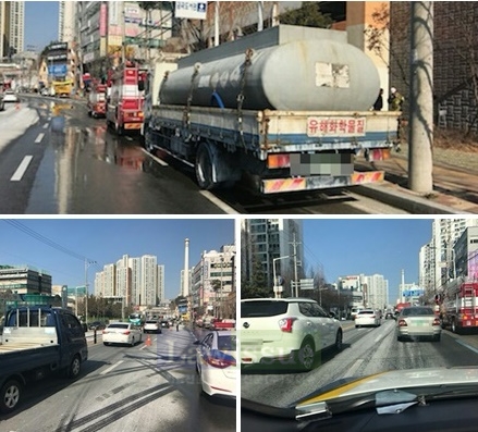 도로에 위험물질인 락스가 유출돼 하얗게 된 도로를 물청소 하고 있다.(사진=부산지방경찰청)