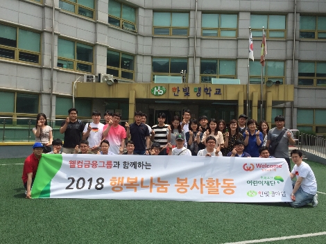강북구에 위치한 한빛맹학교에서 봉사활동에 참여한 웰컴금융그룹 임직원들이 단체사진을 촬영하고 있다. (사진=웰컴금융그룹)