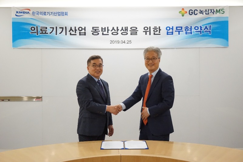 안은억 GC녹십자엠에스 대표(오른쪽)과 이경국 한국의료기기산업협회장(왼쪽)이 지난 25일 경기도 용인 GC녹십자에엠스 본사에서 진행된 업무협약식에서 협약 체결 후 악수를 하고 있다. (사진= GC녹십자엠에스)