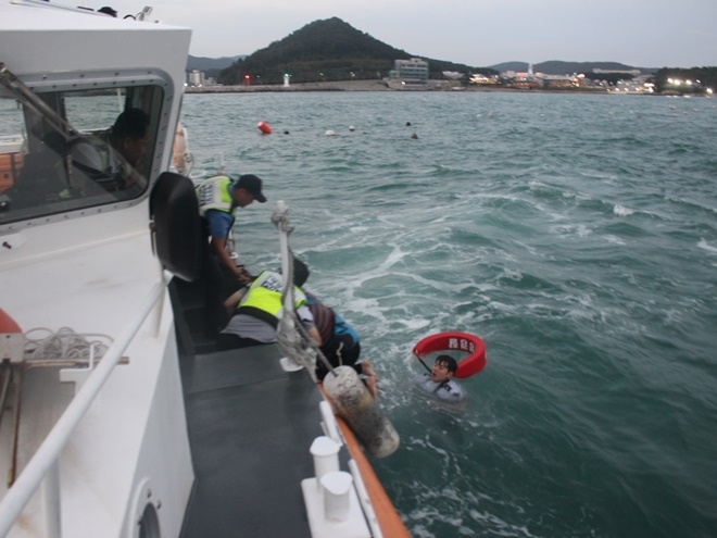 연안구조정에서 표류 윈드서핑객을 구조하고 있다.(사진제공=부산해양경찰서)