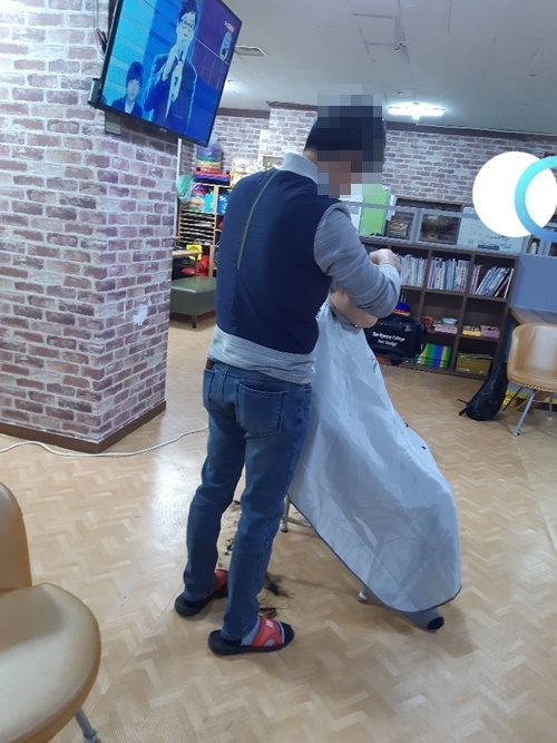 사회봉사대상자가 머리를 손질해 주고 있다.(사진제공=대구준법지원센터)