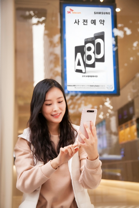 모델이 앞뒤 돌아가는 카메라 탑재 '갤럭시 A80'를 사용하고 있다. 사진=SK텔레콤