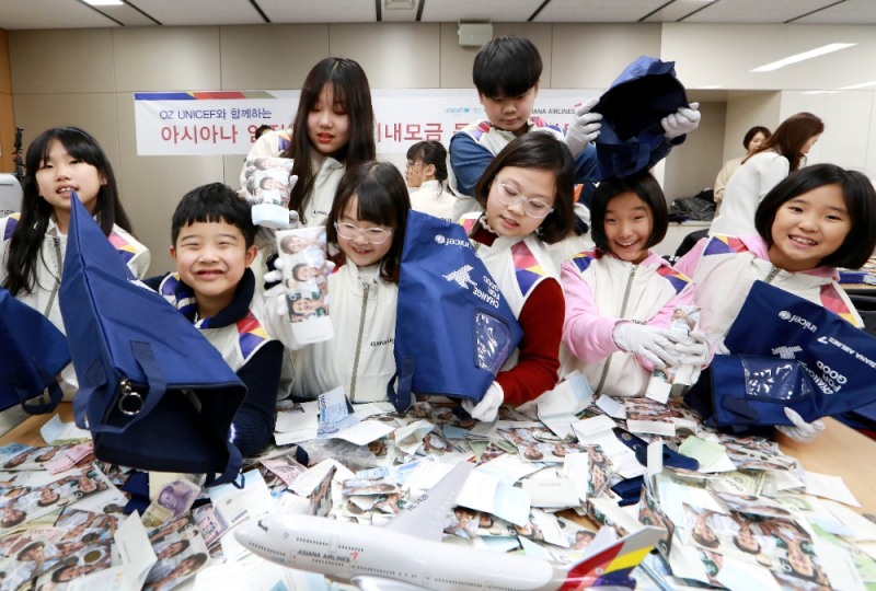 강서구 아시아나항공 교육훈련동에서 겨울방학을 맞이한 임직원 자녀들이 '사랑의 기내 동전 모으기 캠페인'으로 모인 동전의 계수 봉사활동에 참여하고 있다.