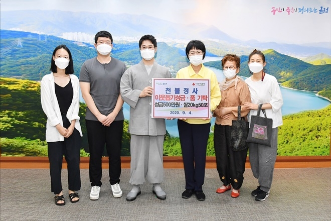 천불정사가 4일 부산 금정구에 이웃돕기 성금과 물품을 기탁하고 정미영 구청장과 기념촬영.(사진제공=부산 금정구)