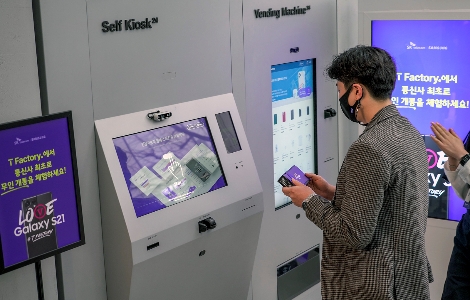 SKT 갤럭시S21 개통 행사에서 1호 개통 고객 배인우씨(서울)가 무인 매장을 통해 폰을 수령하고 있다. 사진=SK텔레콤