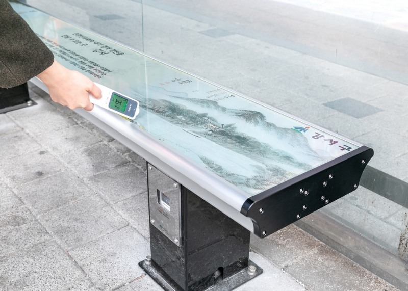 강서구청 버스정류장에 설치된 온열의자에서 온도를 재고 있다.(사진=강서구)