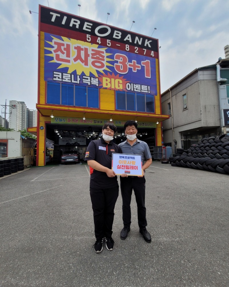 6월 22일 충남 아산시 풍기동에 위치한 타이어뱅크 아산온천점 손병곤 사업주(좌)가 장성준 회장(우)에게 타이어 교환권을 전달한 뒤 기념 촬영을 하고 있다.(사진=타이어뱅크)