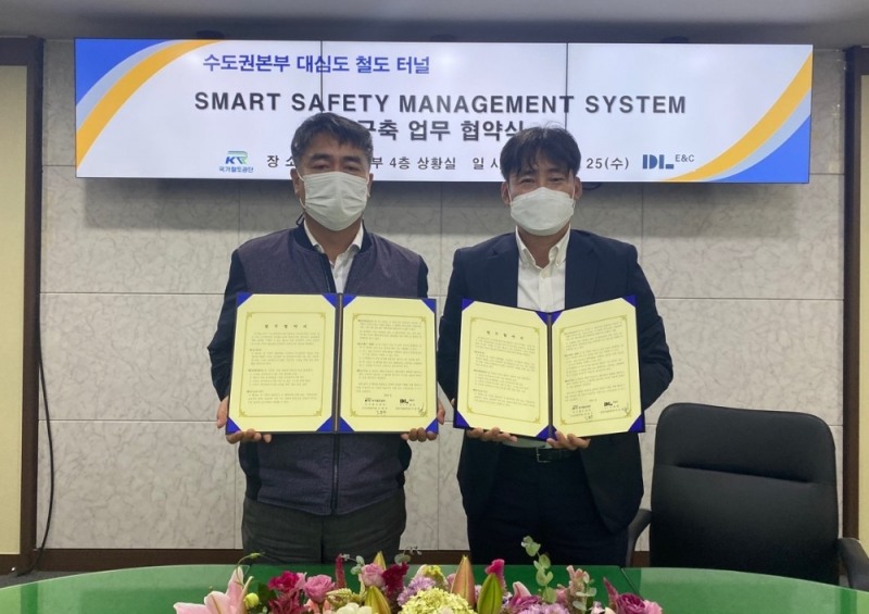 DL이앤씨 이동희 토목사업본부장(오른쪽)과 국가철도공단 김용두 수도권본부장(왼쪽)이 사진 촬영을 하고 있다.(사진=DL이앤씨)