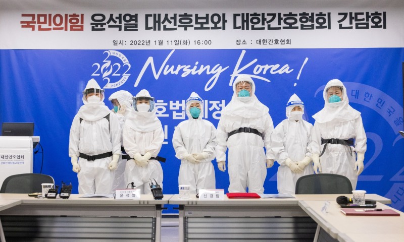 국민의힘 윤석열 대선 후보가 11일 서울 중구 대한간호협회에서 코로나위기대응 간호사 간담회를 개최했다. 윤 후보가 이날 간담회에서 레벨D방호복을 입고 참석자들과 기념촬영하고 있는 모습./사진=연합뉴스