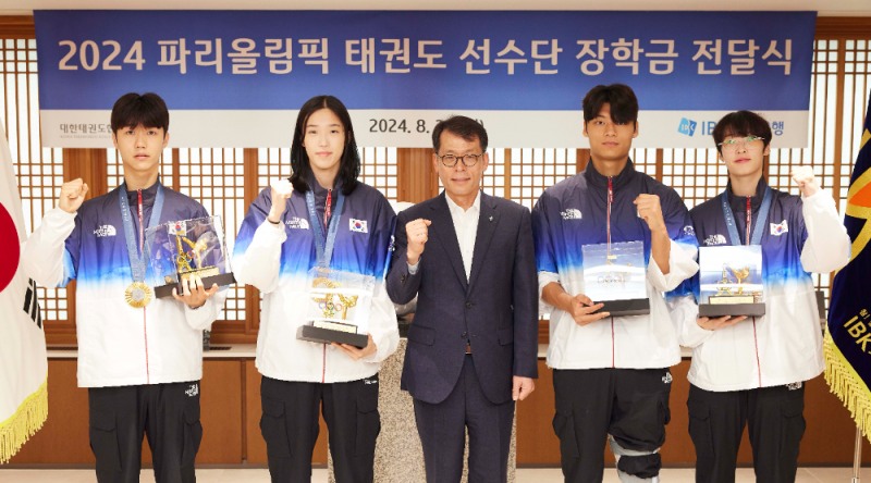 26일 서울 중구 기업은행 본점에서 열린 2024 파리올림픽 태권도선수단 장학금 전달식에서 김성태 IBK기업은행장(가운데)과 태권도 선수단이 기념촬영을 하고 있는 모습. 사진=IBK기업은행