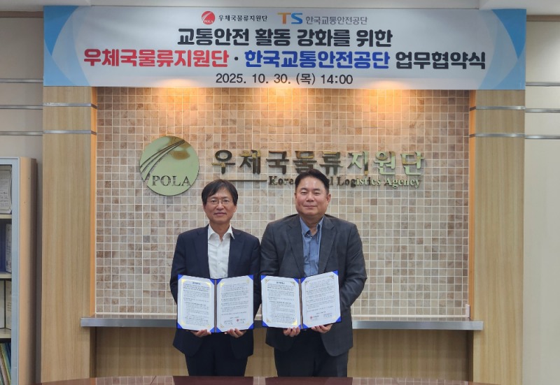 한국교통안전공단 황성재 교통안전정책실장(사진 왼쪽)과 우체국물류지원단 이지훈 소포사업처장이 업무협약 후 사진을 찍고 있는 모습.(사진=TS)