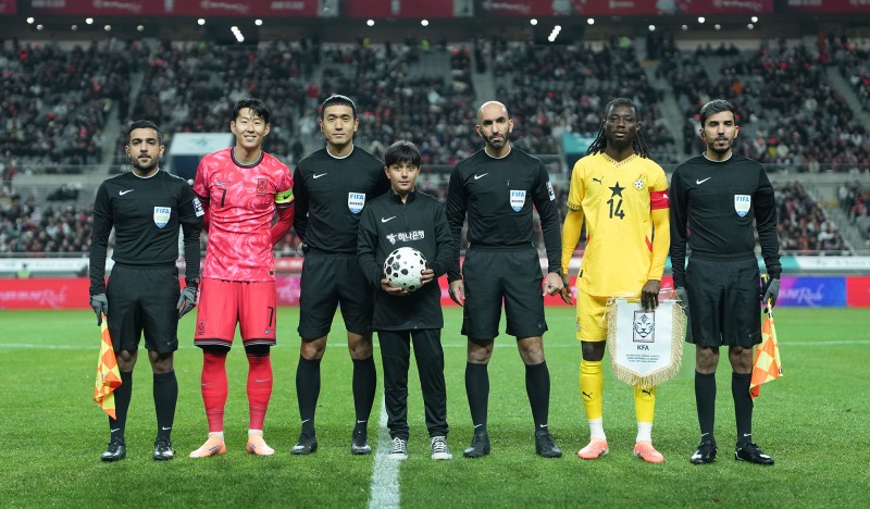 하나은행은 지난 18일 서울월드컵경기장에서 열린 대한민국과 가나의 축구 국가대표팀 A매치 경기에서 이주배경 가정 아동·청소년들에게 '매치볼 키드'와 '기수단'으로 참여할 수 있는 특별한 체험 기회를 제공했다고 밝혔다.이날 경기 시작에 앞서 아프가니스탄 출신 '매치볼 키드' 마시(Masih)가 양 팀 주장 및 심판진과 함께 기념촬영을 하고 있다. 사진=하나은행