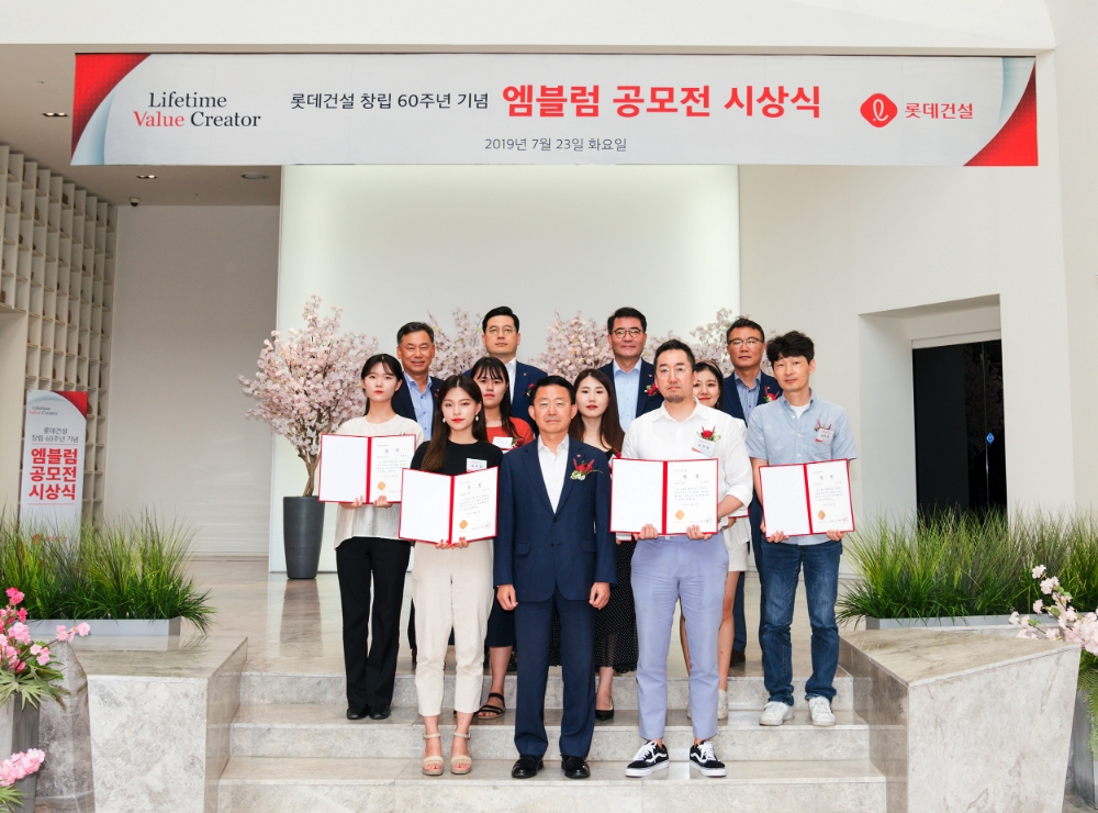 롯데건설 창립 60주년 기념 엠블럼 공모전 시상식에서 롯데건설 하석주 대표이사(첫 번째 줄 가운데)와 임직원 및 수상자들이 기념촬영을 하고 있다.(사진=롯데건설)