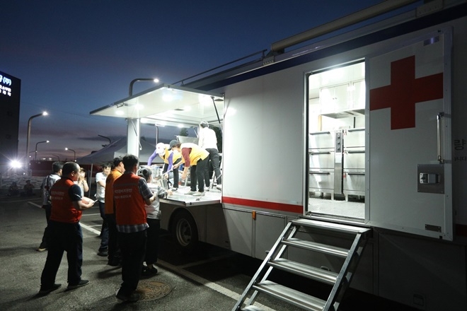 6월 24일 오전 화성 배터리공장 화재 발생 현장에 급파된 대한적십자사 직원과 봉사원들이 구조대원들에게 석식을 제공하고 있다. (사진제공= 대한적십자사)