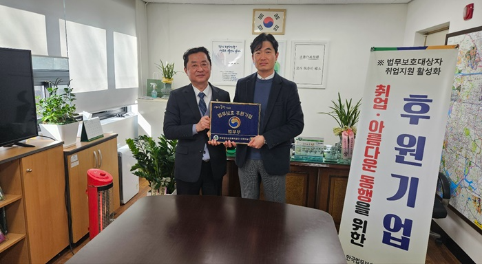 최규삼 지부장과 윤영중 대표(사진우측)가 현판을 들고 기념촬영.(사진제공=한국법무보호복지공단 인천지부)