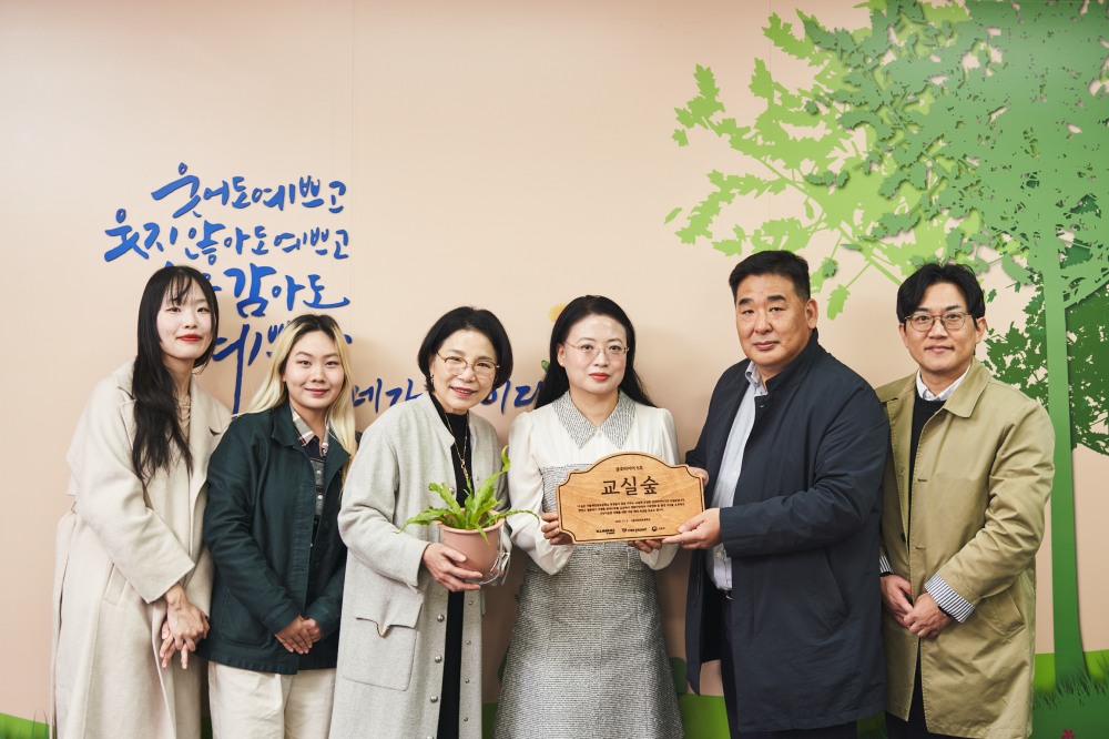 (왼쪽 5번째) 강진구 금호타이어 경영지원팀장, (왼쪽 4번째) 이귀염 서울세검정초등학교 교장이 교실숲 조성을 기념하여 사진촬영을 하고 있다.(사진=금호타이어)