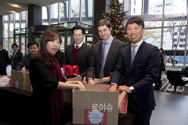 ▲11월27일스테이트타워남산1층로비에서진행된‘사랑나눔행사’에서세종변호사와직원들이홀몸노인들에게전달한방한용품선물박스를만들고있다.(사진제공=법무법인세종)