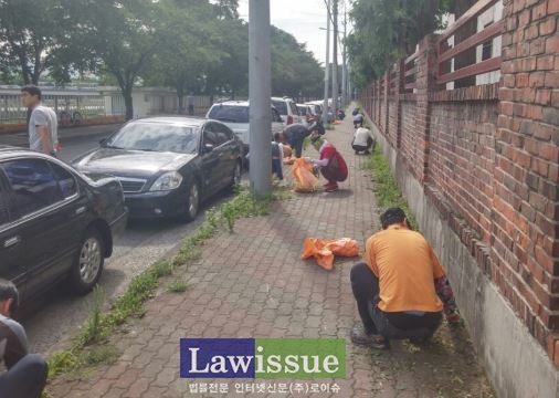 사회봉사대상자들이 제초작업을 하고 있다.