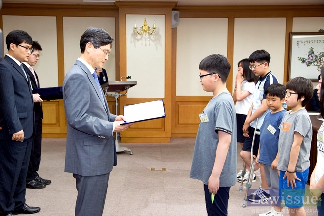 황한식 부산고법원장이 어린이법관에게 위촉장을 수여하고 있다.