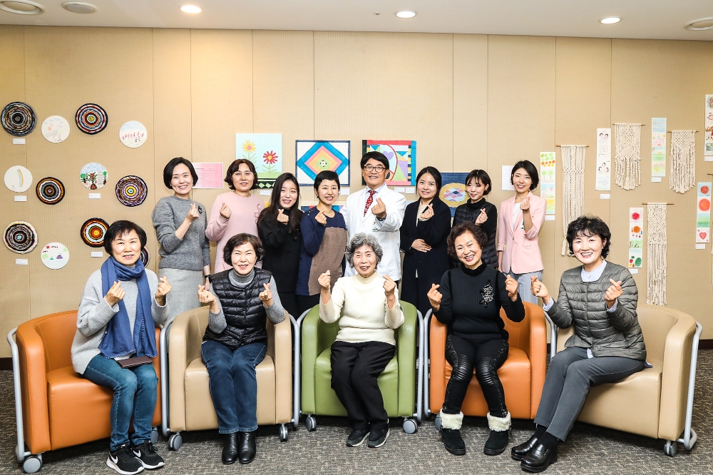 지난 3일 이대여성암병원 다목적실에서 있은 ‘메이킹 마이 리틀 포레스트(Making My Little Forest)’ 전시회에서 참여한 환우들과 봉사자 백남선 이대여성암병원장이 기념 촬영을 하고 있다. (사진=이대목동병원)