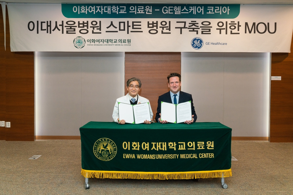 문병인 이화여자대학교 의무부총장 겸 의료원장과 프란시스 반 패리스 GE헬스케어코리아 대표이사 사장이 양해각서 체결 후 기념 촬영을 하고 있다.