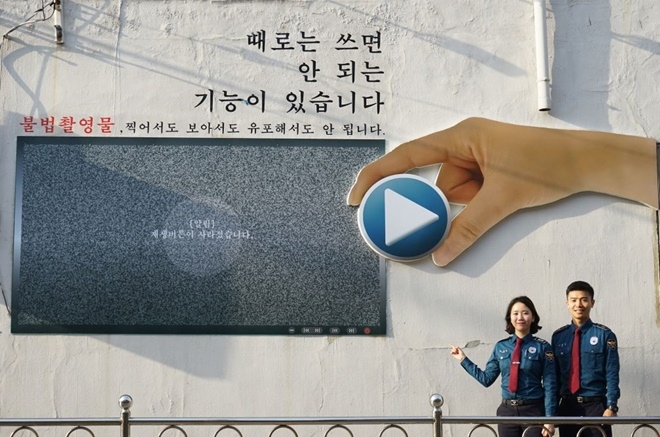 부산 남구 문현동 곱창골목에 위치한 문현4치안센터 외벽에 설치된 불법촬영물근절 이색광고판.(사진제공=부산경찰청)