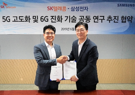 업무협약식에 참석한 SK텔레콤 박진효 ICT기술센터장(왼쪽)과 삼성전자 전재호 네트워크사업부 개발팀장(오른쪽)이 기념촬영을 하고 있다. 사진=SK텔레콤