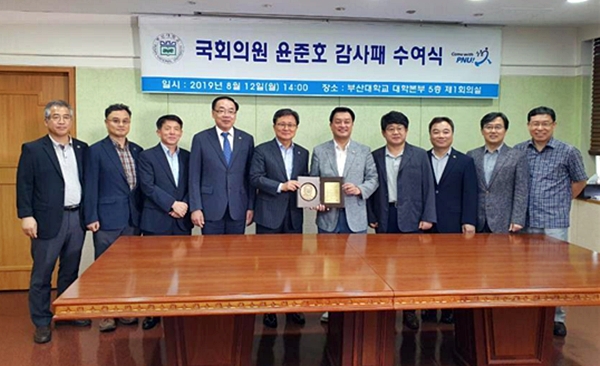 윤준호 국회의원(사진우측 5번째)이 부산대 감사패를 받고 기념촬영.(사진제공=윤준호의원실)