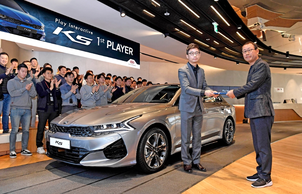 ‘3세대 K5’ 퍼스트플레이어로 선정된 김동귀 씨가 이한응 판매사업부장 등 기아차 임직원들과 함께 기념 촬영을 하는 모습.(사진=기아자동차)