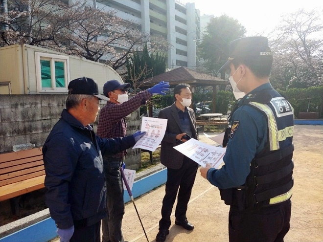 코로나19 감염 예방 전단지를 나눠주고 있다. (사진제공=부산경찰청)