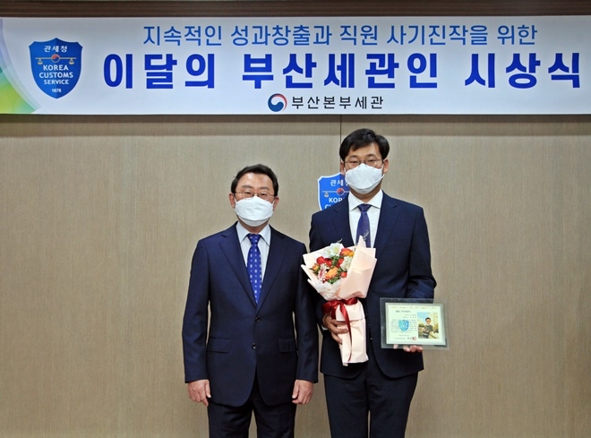 이근후 부산본부세관 통관국장(사진왼쪽)이 5월의 부산세관인에 선정된 김종문 관세행정관과 기념촬영.(사진제공=부산본부세관)