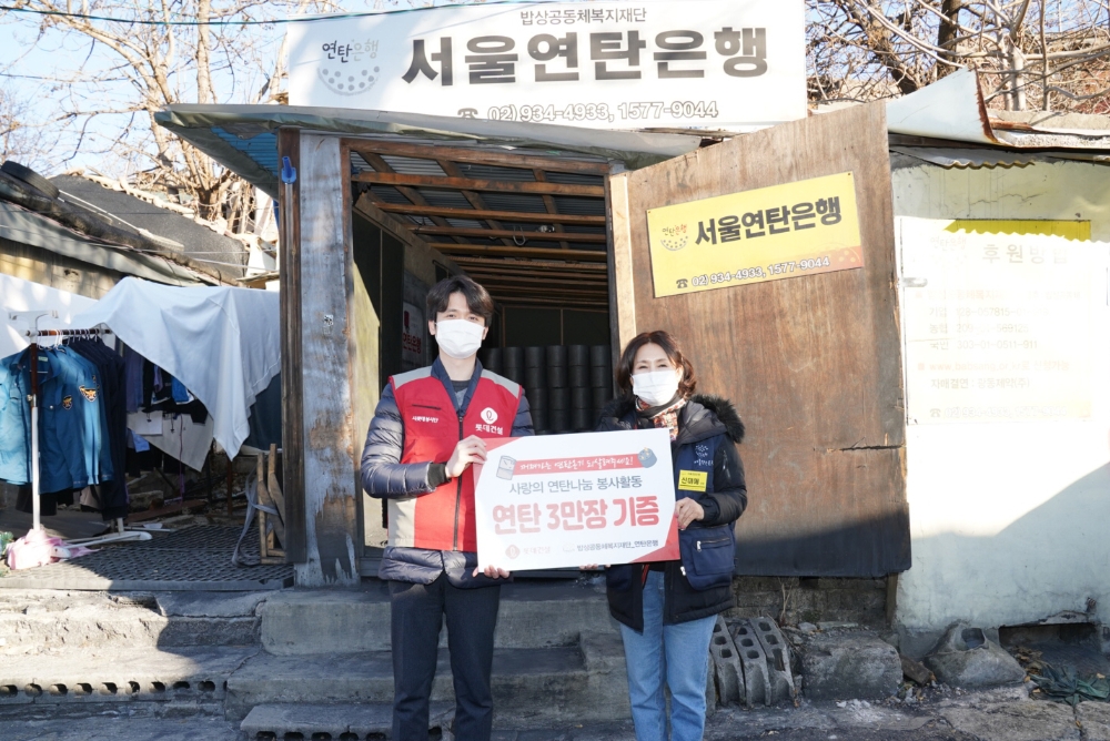 롯데건설 관계자(사진 왼쪽)와 서울연탄은행 관계자가 기념촬영을 하고 있다.(사진=롯데건설)