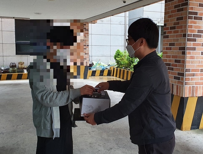 구미준법지원센터 보호관찰관이 5월 17일 성년에 도달한 보호관찰 청소년의 주거지를 직접 방문해 성년의 날 기념 케이크를 전달하고 있다.(사진제공=구미준법지원센터)