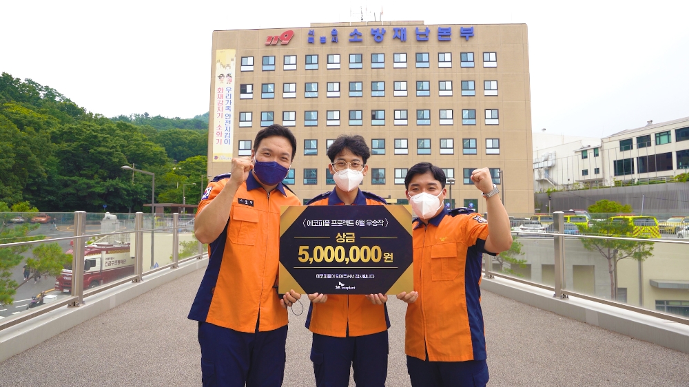 우승작 속 주인공인 서울재난본부 소방관들이 상금 전달식에서 기념촬영을 하는 모습.(사진=SK에코플랜트)
