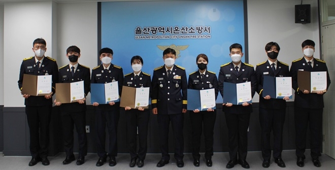 박정진 온산소방서장(가운데)이 8명에게 하트·브레인·트라우마 세이버 인증서와 인증배지를 수여하고 기념촬영.(사진제공=울산 온산소방서)