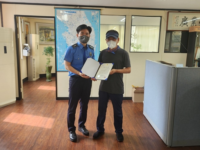 손성민 경비구조과장이 이경상씨에게 서장 명의 감사장을 전달하고 기념촬영.(사진제공=부산해양경찰서)