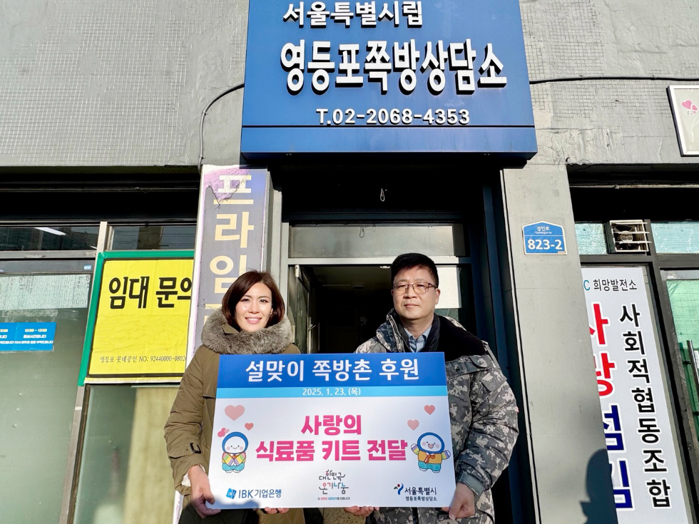 23일 기업은행 관계자가 서울특별시립 영등포쪽방상담소 관계자에게 식료품 키트를 전달한 후 기념촬영을 하고 있는 모습. 사진=IBK기업은행