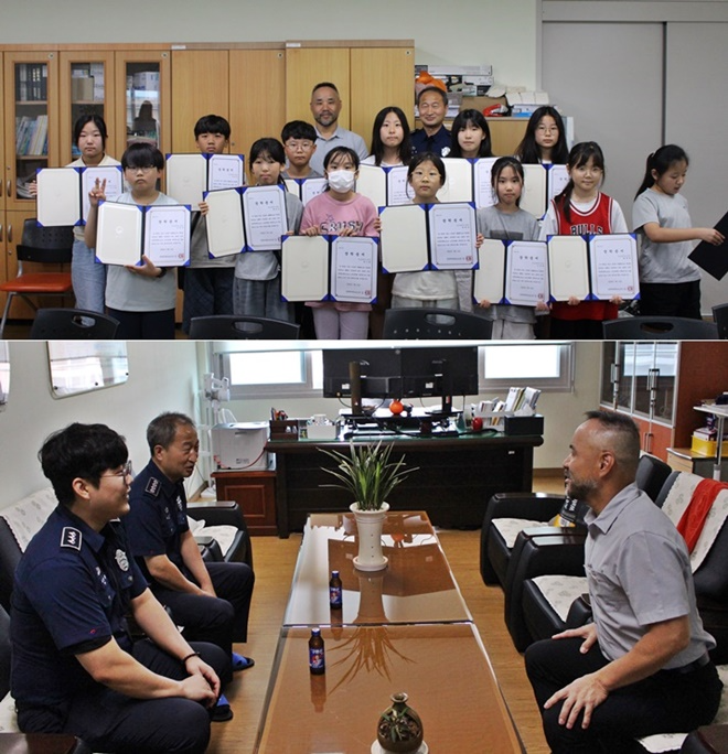 진보초등학교학생들이 장학증서를 내보이며 기념촬영을 하고 있다.부소장 등과 교장이 담소를 나누고 있다.(사진제공=경북북부제1교도소)