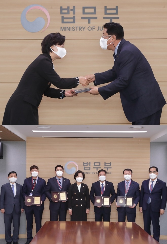 추미애 법무부장관이 16일 오후 정부과천청사에서 열린 ‘출소자 고용 우수기업 감사패 수여식’ 에서 강선국 퓨전테크 대표(오른쪽)에게 감사패를 수여하고 수상자들과 기념촬영.(사진제공=법무부)