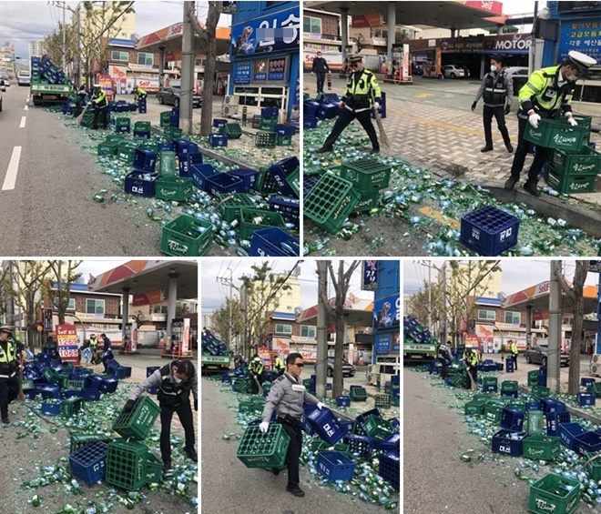 출동한 경찰들이 도로에 낙화돼 깨진 소주와 박스를 옮기고 있다.(사진제공=부산경찰청)