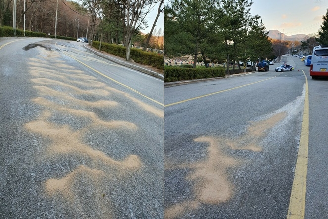 상수도 파열로 노면결빙돼 모래가 살포돼 있다. (사진제공=부산경찰청)