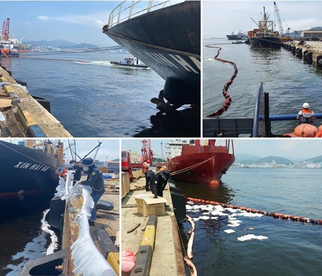 외국적 선박 기름유출로 오일펜스 설치하고 유흡착재를 이용해 기름을 제고하고 있다.(사진제공=부산해양경찰서)