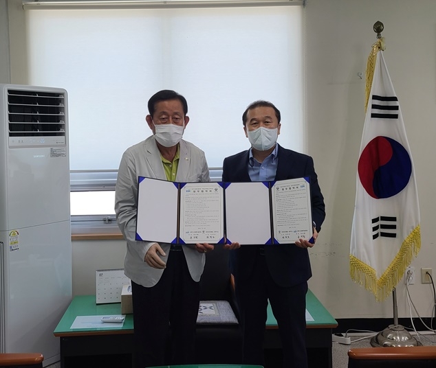 (사진왼쪽부터) 유만행 공주시사회복지협의회장과 김경모 소장이 21일 협약서를 내보이며 기념촬영.(사진제공=공주보호관찰소)