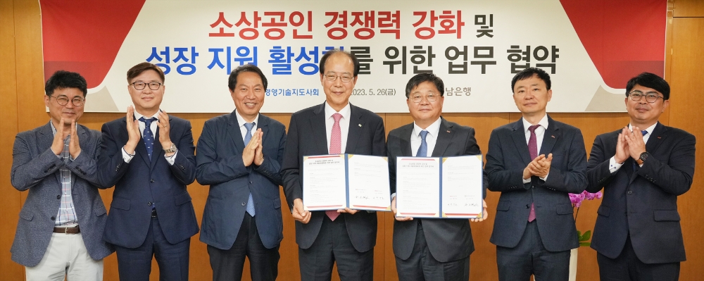 BNK경남은행 박상호 상무(사진 오른쪽 세번째)와 한국경영기술지도사회 김오연 회장이 ‘소상공인 경쟁력 강화 및 성장 지원 사업 활성화를 위한 업무 협약’을 체결하고 있다. 사진=BNK경남은행