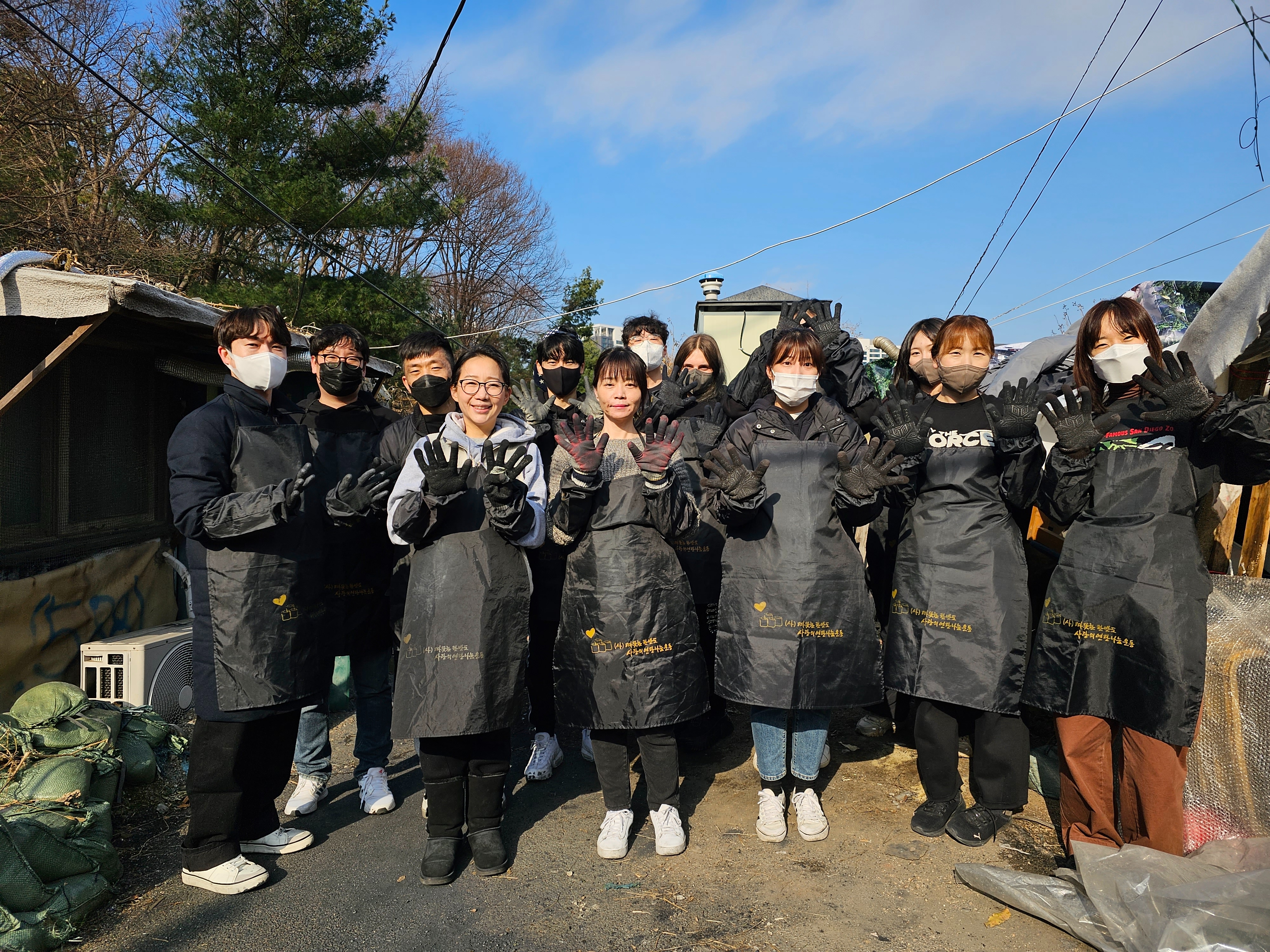 아트앤디자인인터내셔널 임직원들이 지난 2일, 서울 강남구 구룡마을에서 연탄 나눔봉사활동을 했다.(사진=아트앤디자인인터내셔널)