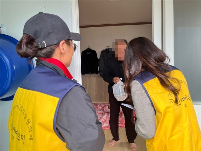 일광읍지역사회보장협의체 위원이 독거가구에게 반찬을 배달하고 안부를 묻고 있다.(사진제공=부산 기장군)