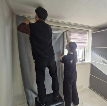 보호관찰 대상자 자녀의 학업 환경을 위해 커튼을 달아주고 있다.