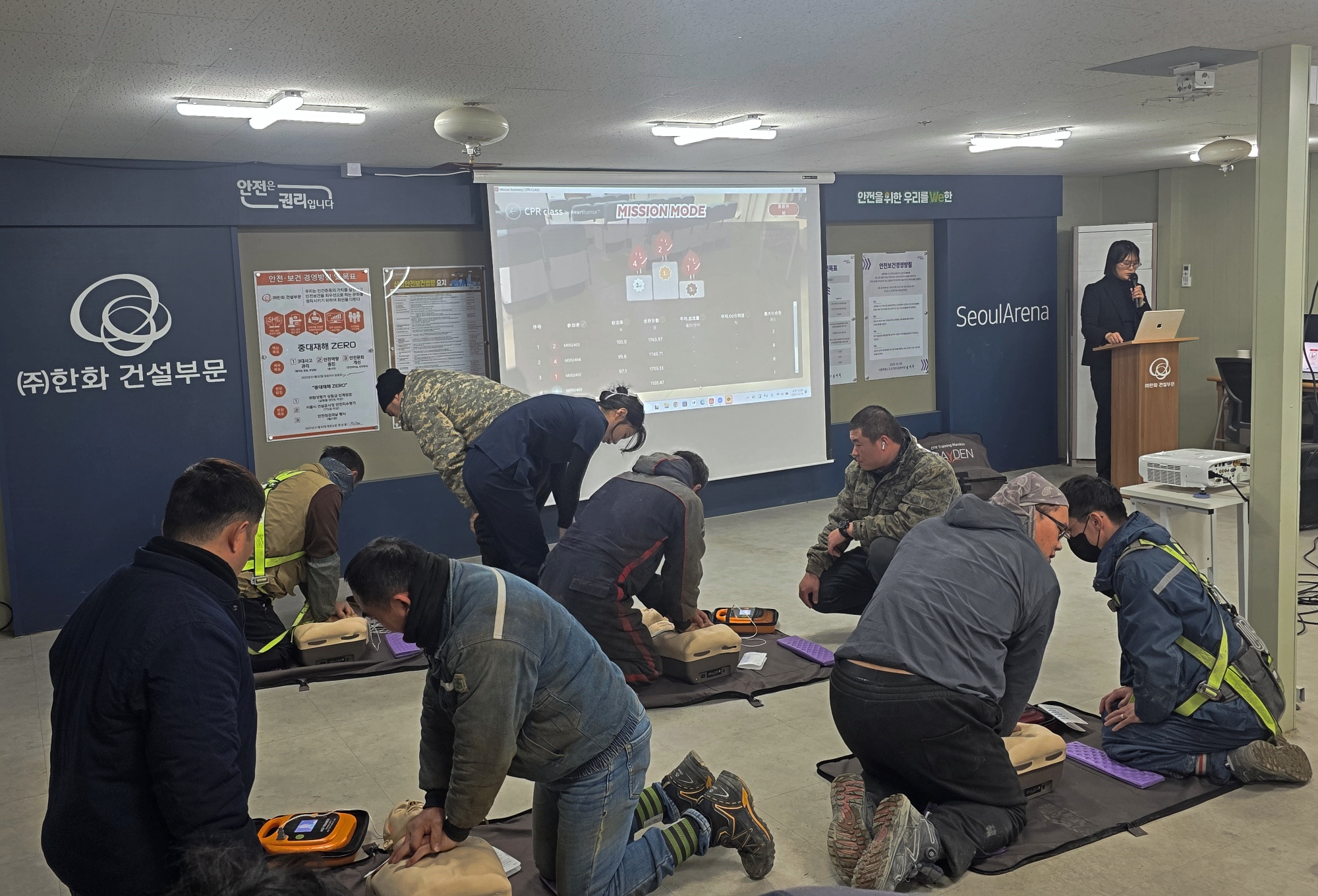 외국인 근로자들이 상황에 맞춰 자동심장충격기(AED)를 사용하고 있다.(사진=한화 건설부문)